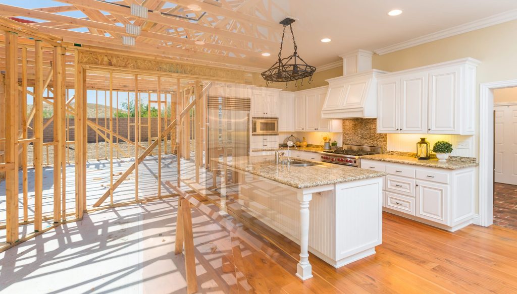 Kitchen under renovation featuring white cabinetry, granite countertops, and exposed wooden framing, illustrating spring home renovation trends and building materials.